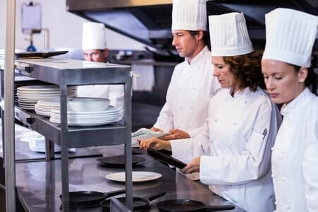 staff cleaning commercial kitchen