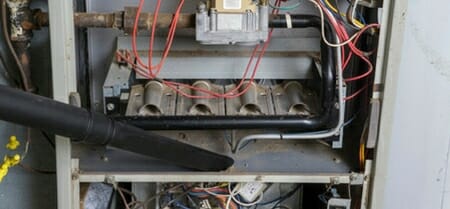 vacuuming dirty furnace