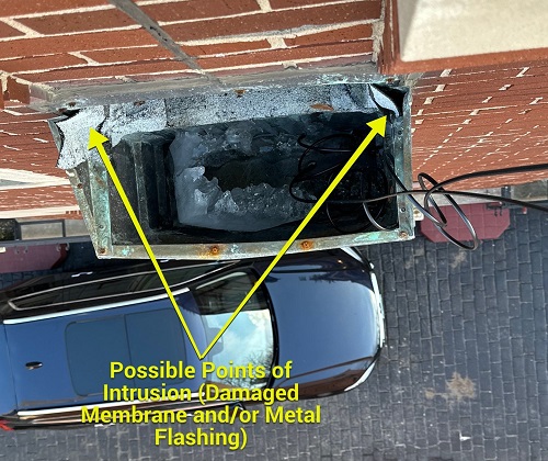 water damage from clogged scupper box on the rooftop patio